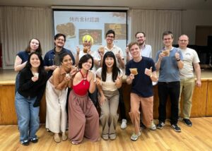 Upper Intermediate 401 students celebrating the Mid-Autumn Festival with mooncakes and a pomelo-peel hat